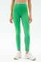 A person wears SPLITS59 Easton Rigor High Waist 7/8 leggings in Grass/White—bright green with a black leg stripe—paired with white athletic shoes, standing against a plain background.