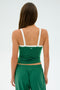 A person with long brown hair, wearing the SPLITS59 Monah Rigor Tank in Arugula/White and matching green spandex pants, faces away against a plain background.