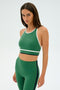 A person wearing the Layla Airweight Bra in Arugula/Indigo by SPLITS59 poses against a plain background.