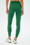 A person wearing SPLITS59's Layla Airweight High Waist 7/8 leggings in Arugula/Indigo paired with white sneakers, viewed from the back against a plain background.