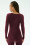 A person with braided hair models the SPLITS59 Chloe Airweight Jumpsuit in Dark Cherry, standing with their back to the camera against a plain light background.