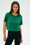 A person wearing the SPLITS59 Djuna Crop Ringer with black pants stands against a plain light background.