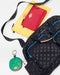 The SPLITS59 MZW x Splits59 Duffle, a yellow pouch with a red pouch on top, and a round green keychain pouch are arranged on a white surface.