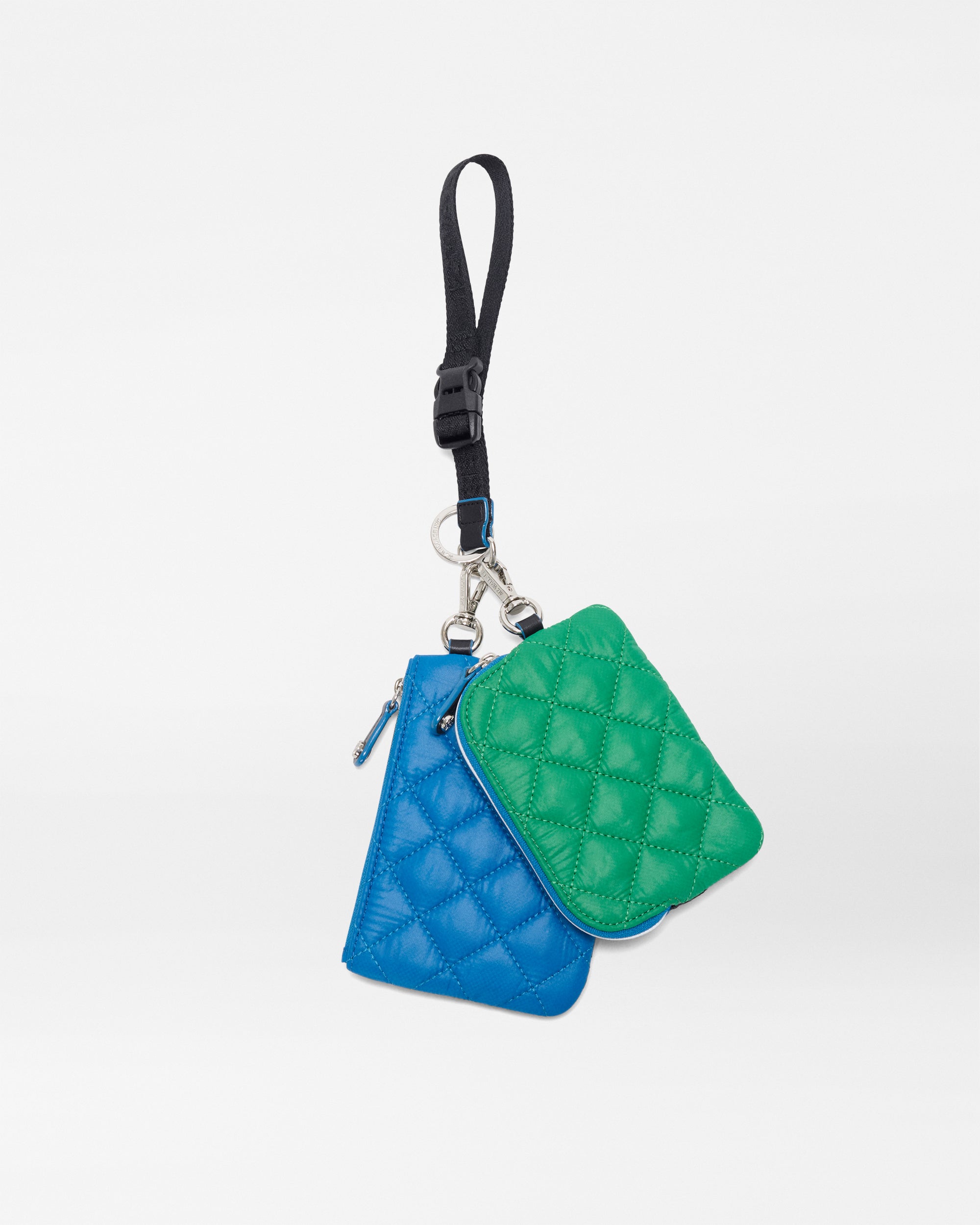 The SPLITS59 MZW x Splits59 Metro Key Pouch Wristlet features two quilted pouches, green and blue, attached to a black strap with clasp, shown against a plain white background.