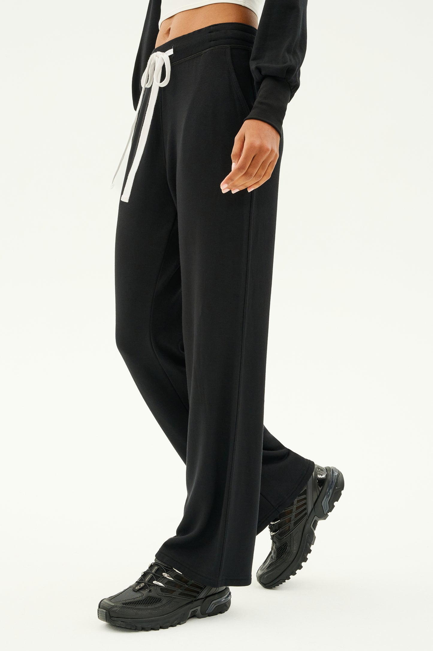 A person in Raven Fleece Full Length Sweatpant - Black by SPLITS59 stands against a plain background, exuding the effortless sophistication of ultra-luxe fleece craftsmanship MADE IN LOS ANGELES.