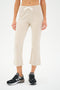 Person wearing Brooks Fleece Cropped Flare in Heather Oatmeal by SPLITS59 and black New Balance sneakers.