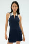 A woman stands against a plain background wearing the SPLITS59 Austin Rigor Dress in indigo and white, featuring a sleeveless design, white collar, and zippered front.