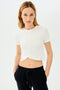 A model wearing a SPLITS59 Daisy Jersey Tee in White and black sweatpants.