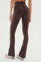 A person is shown from the back, standing against a plain background, wearing the SPLITS59 Raquel High Waist Flared Legging in Dark Chocolate with white sneakers.