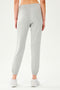Front view of woman wearing light grey jogger  paired with creme shoes