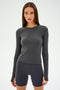 Against a light gray background, a person wears the SPLITS59 Airweight Lite LS Waist Length in Graphite with matching shorts, ideal for quick-dry gym workouts.