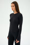 A person with long hair wears the SPLITS59 Airweight Lite LS Waist Length shirt and pants in black, made from quick-dry fabric, against a plain background.