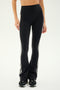A person wearing the SPLITS59 Raquel High Waist Flared Legging in Black/White paired with black sneakers stands against a plain background.