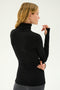 A person with long hair, seen from the back, wears a supremely soft SPLITS59 Jackson Rib Full Length Turtleneck in black with thumbhole cuffs, perfect for yoga, standing against a plain light background.