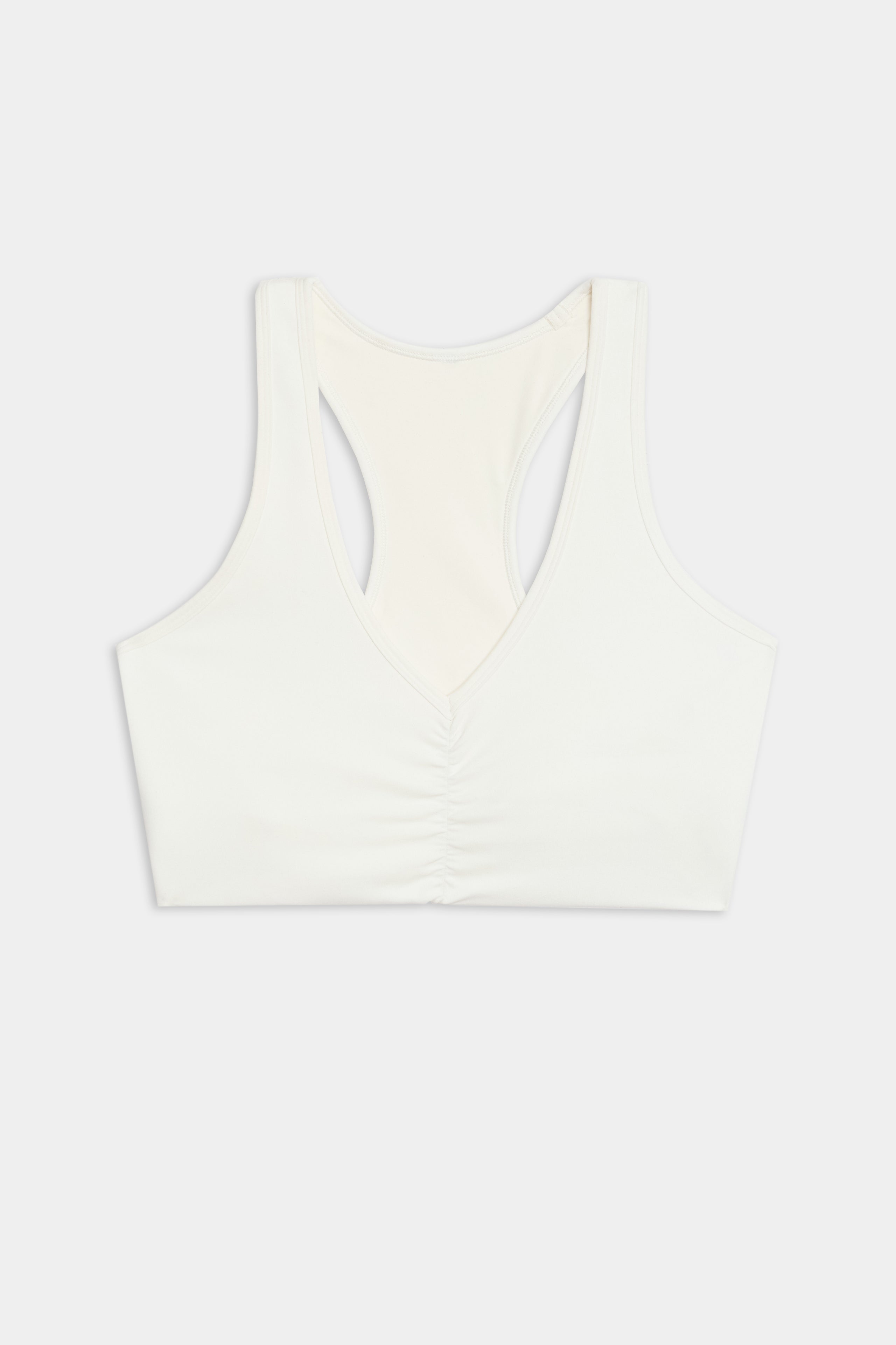SPLITS59's Airweight Bra with Ruching in white, featuring gathered front detail, is shown against a plain backdrop.