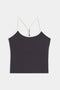 The SPLITS59 Airweight Tank is a black cropped top featuring white spaghetti straps and a white trim, displayed against a plain white background.