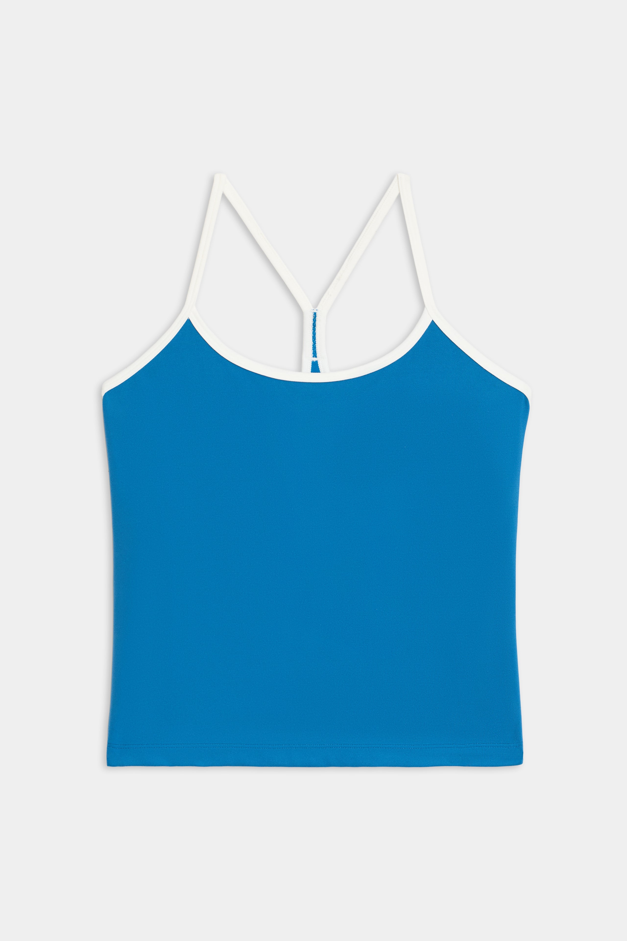The Airweight Tank by SPLITS59 is a blue camisole top with white spaghetti straps and trim, shown against a plain white background.