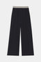 The Michele Airweight Trouser by SPLITS59 is a wide-leg black pant with an elastic waistband and two white stripes, shown laid flat on a plain background.