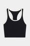 The SPLITS59 Amber Airweight Bralette is a black sports bra with white trim and a racerback design, shown on a plain white background.