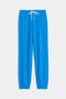 The SPLITS59 Andie Oversized Fleece Sweatpant in Riviera features bright blue ultra-luxe fleece, an elastic waistband, white drawstring, and elastic cuffs—ideal for cool weather workouts. Shown on a plain white background.