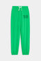 The SPLITS59 Andie Oversized Fleece Varsity 59 Sweatpant in Grass features an elastic waistband, white drawstring, elastic cuffs, and "59" on the left thigh—perfect for cool weather workouts.