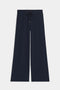 The SPLITS59 Brynn Airweight Pant in Indigo features a wide-leg silhouette, comfortable nylon-spandex blend, elastic waistband with drawstring, and is shown on a white background.
