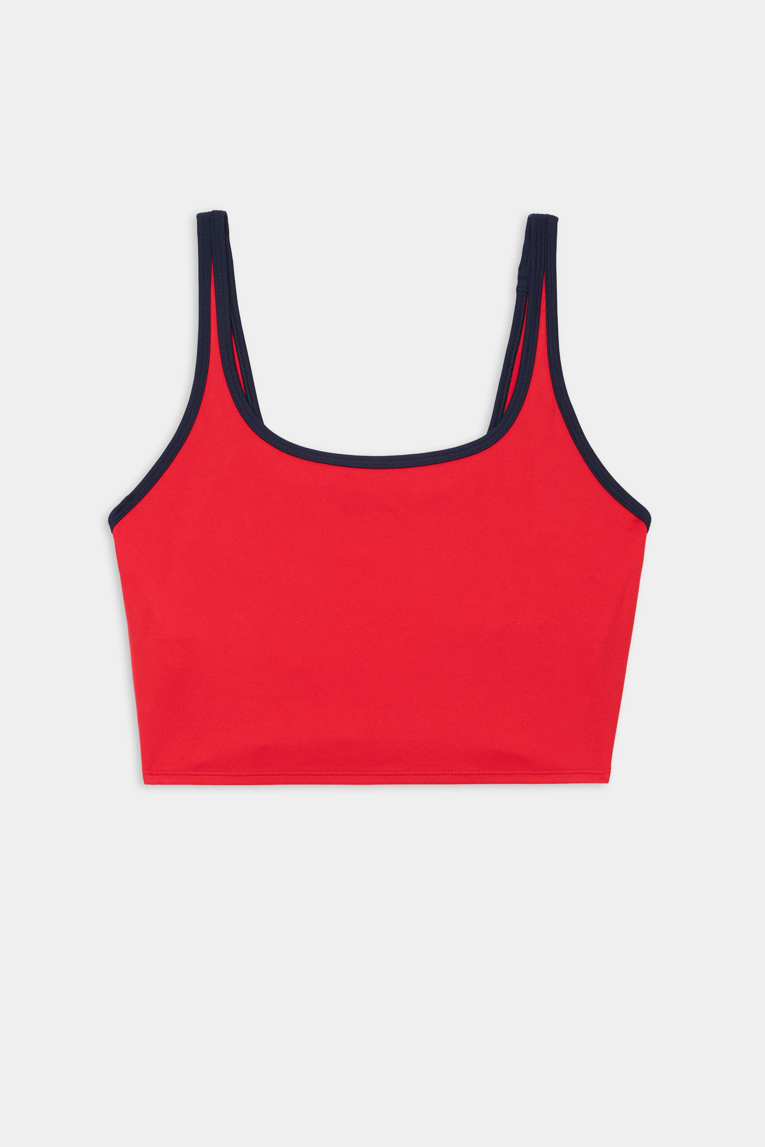 The SPLITS59 Cait Rigor Bralette in Pirate Red/Indigo features navy straps and trim, crafted from a nylon-spandex blend, and is shown on a plain white background.