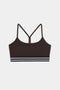 The SPLITS59 Cali Active Rib Bra in Heather Dark Chocolate features thin straps, a racerback design, and a black and white striped elastic band for stylish support during workouts.