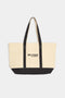 Yellowish white tote bag with black bottom and straps
