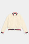 The SPLITS59 Willa Sherpa Jacket in cream is a cozy bomber with a zip front and red, white, and navy striped ribbed cuffs, collar, and hem—perfect sportswear for chilly days.