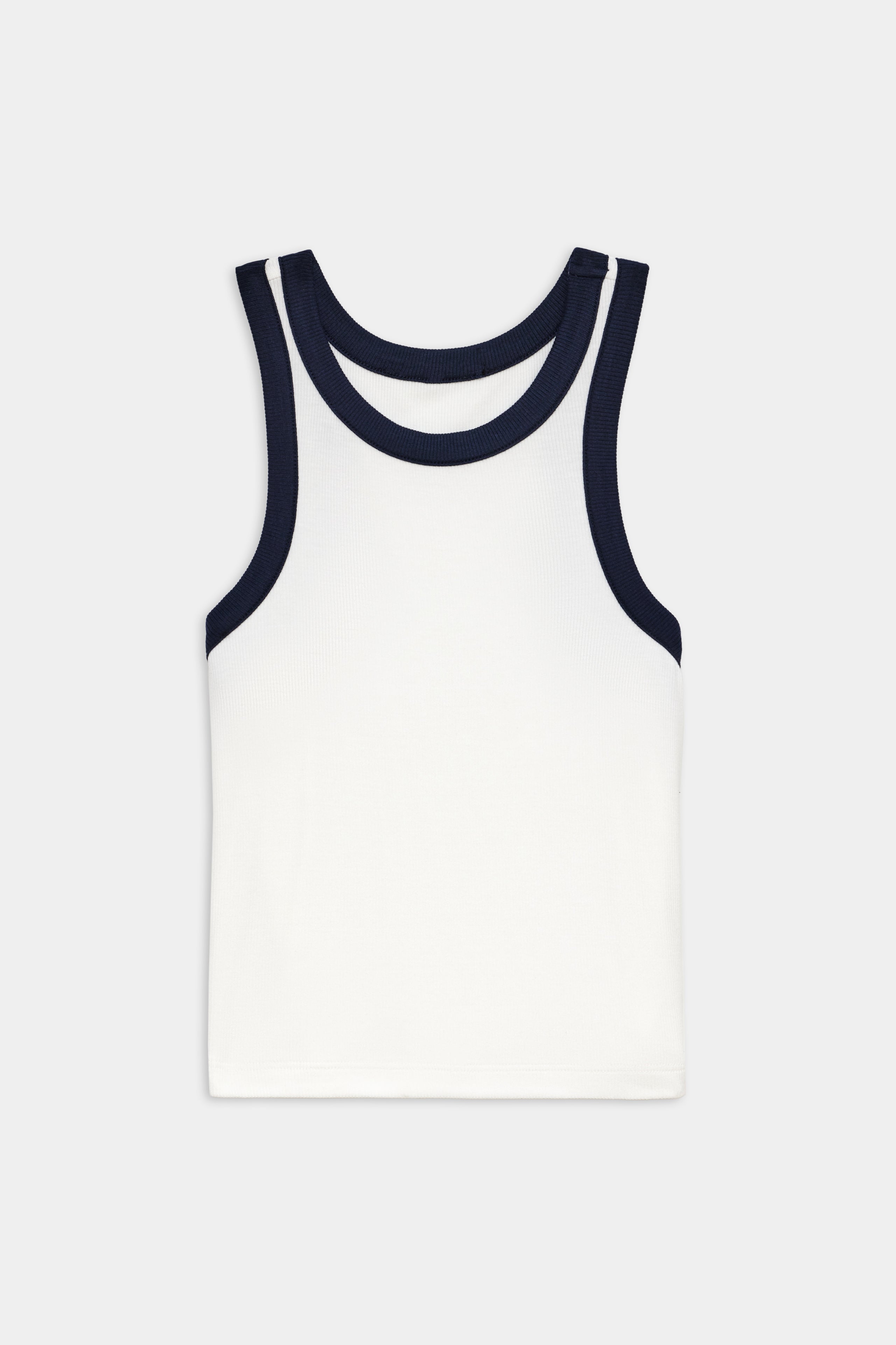 White sleeveless tank top with dark navy blue trim around the neckline and armholes, laid flat on a plain light gray background.