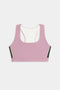 The SPLITS59 Lexi Rigor Bra is a mauve sports bra featuring a racerback, white lining, and green and white side panels, shown on a plain white background.