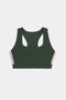 The SPLITS59 Lexi Rigor Bra, a dark green racerback sports bra featuring pink and white side stripes, is displayed on a white background.