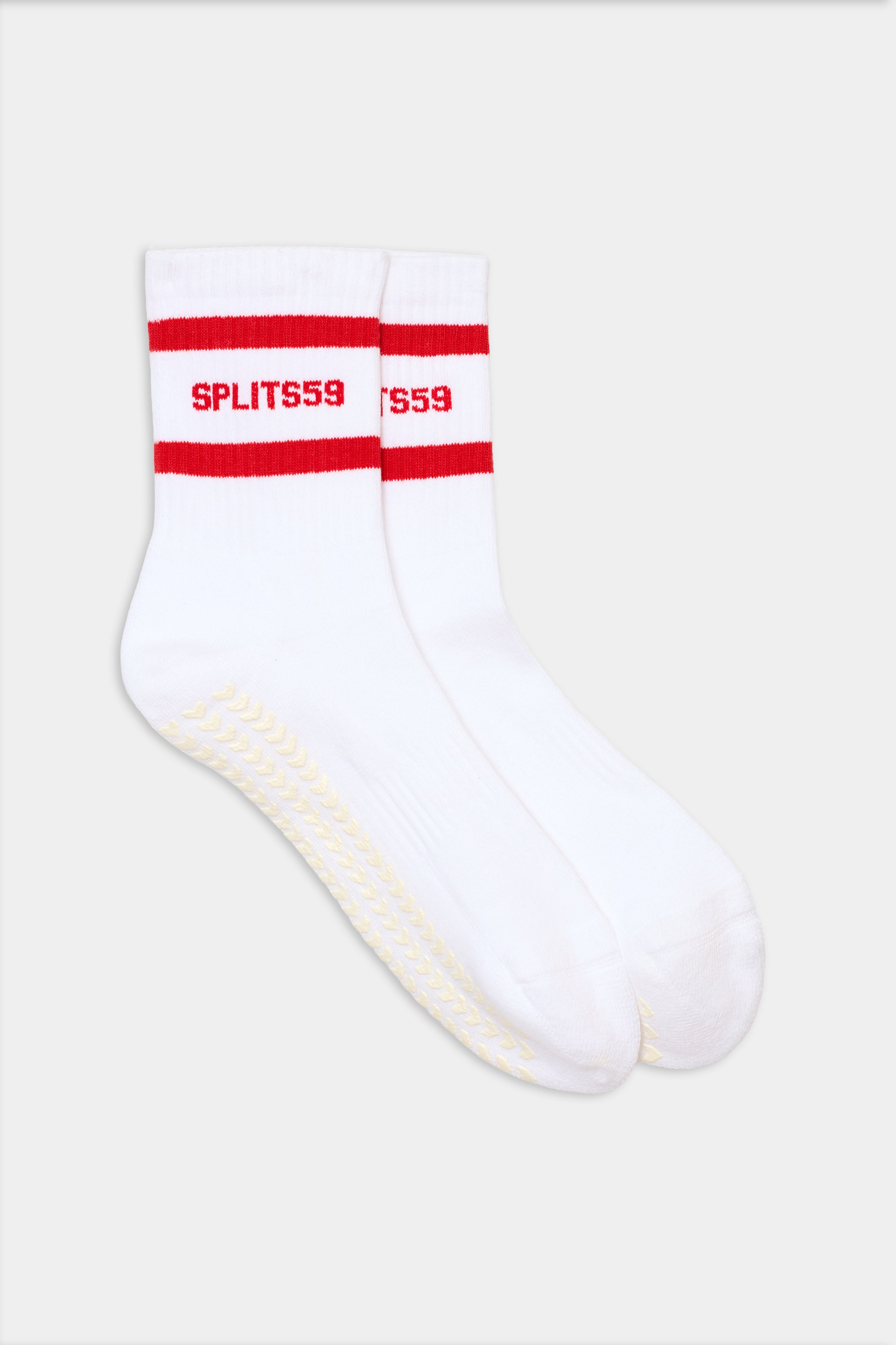 The SPLITS59 Logo Stripe Ankle Socks With Grip in White/Lotus Red feature red stripes and "SPLITS59" text near the top, delivering a vintage sporty look.