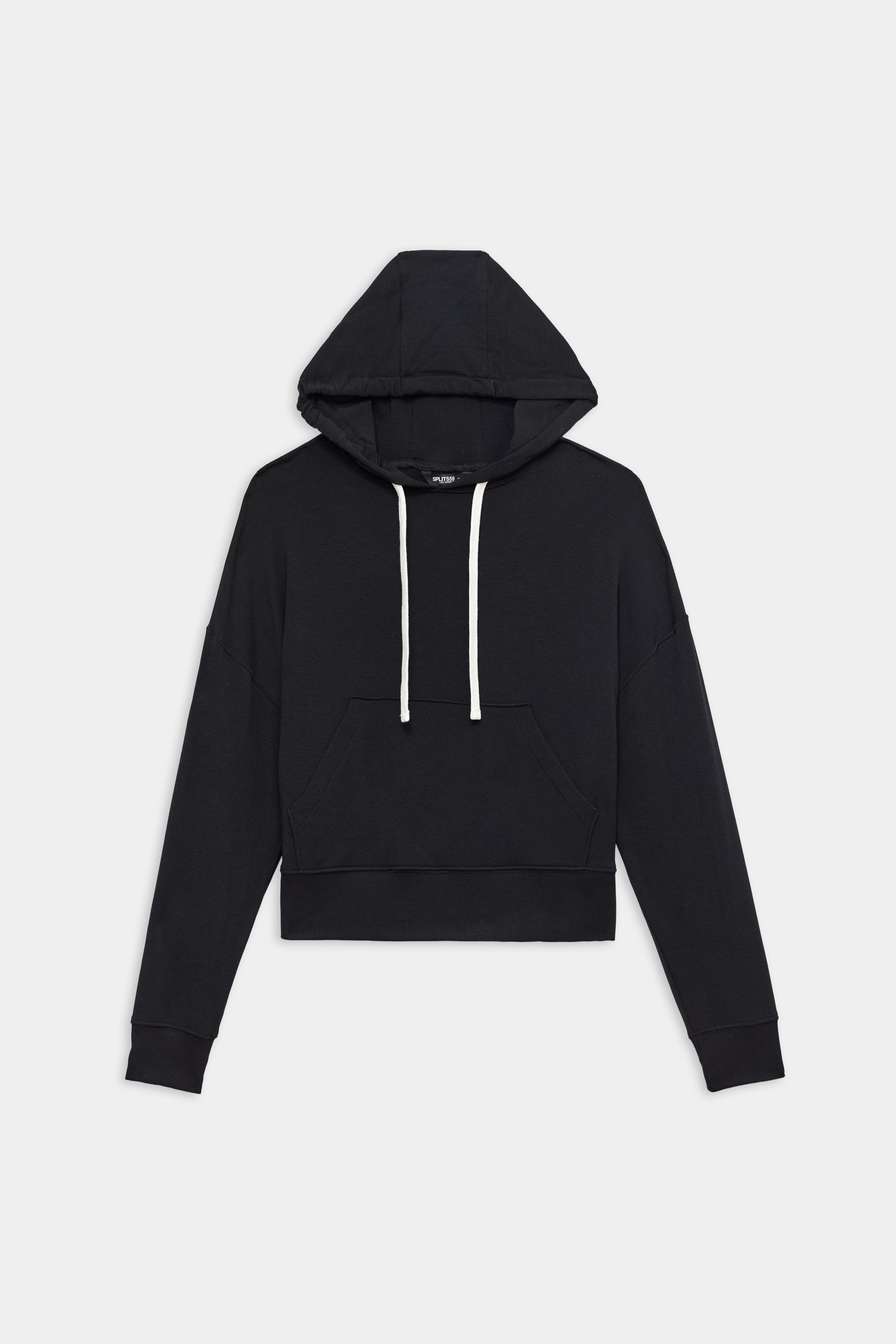 The SPLITS59 Joey Long Sleeve Hoodie in black features a soft spandex blend, white drawstrings, long sleeves, a kangaroo pocket, and ribbed cuffs, shown laid flat on a white background.