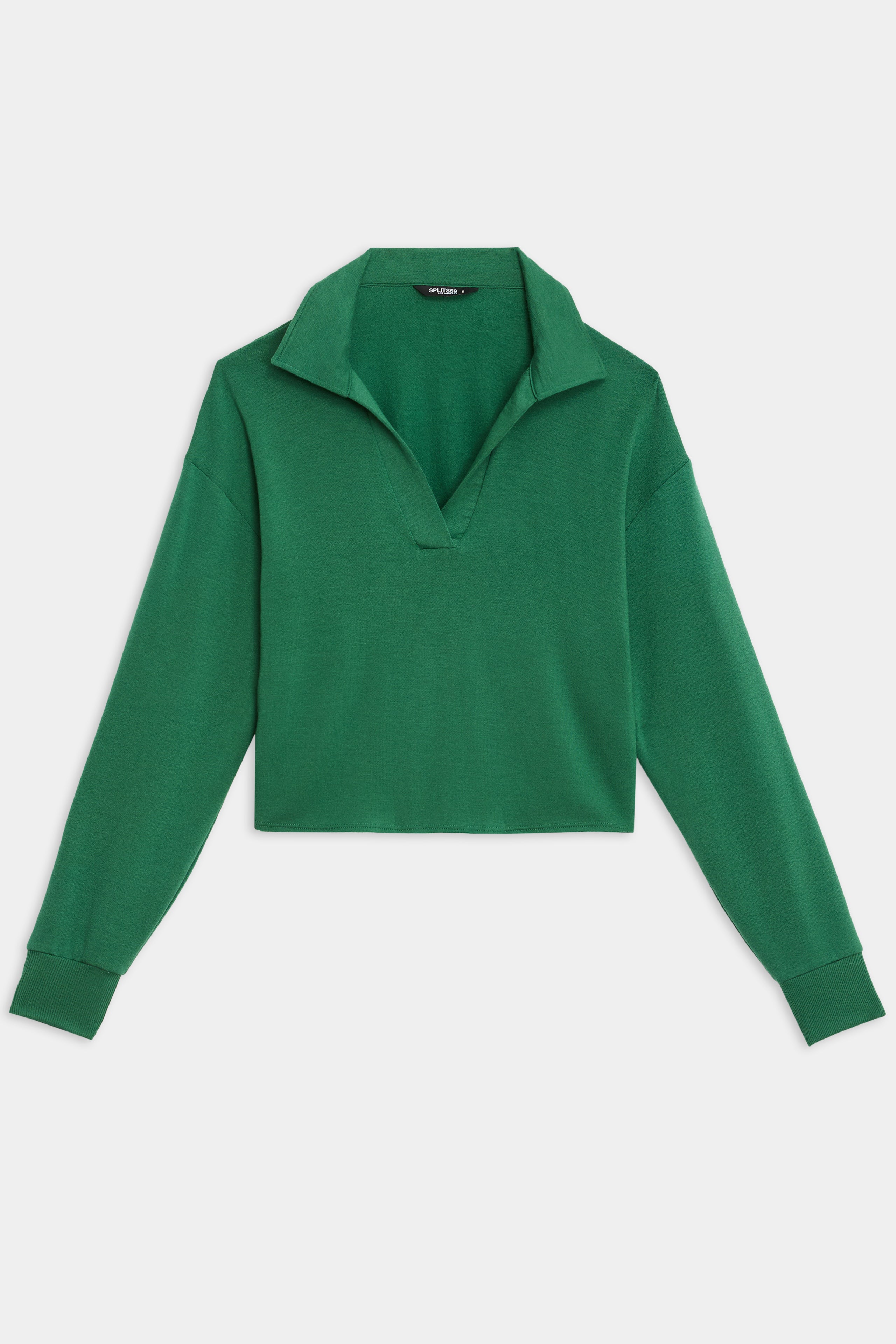 The Joan Fleece Polo Sweatshirt by SPLITS59, in Arugula, features long sleeves, a V-neck opening, and a collared design; it's showcased laid flat on a white background.