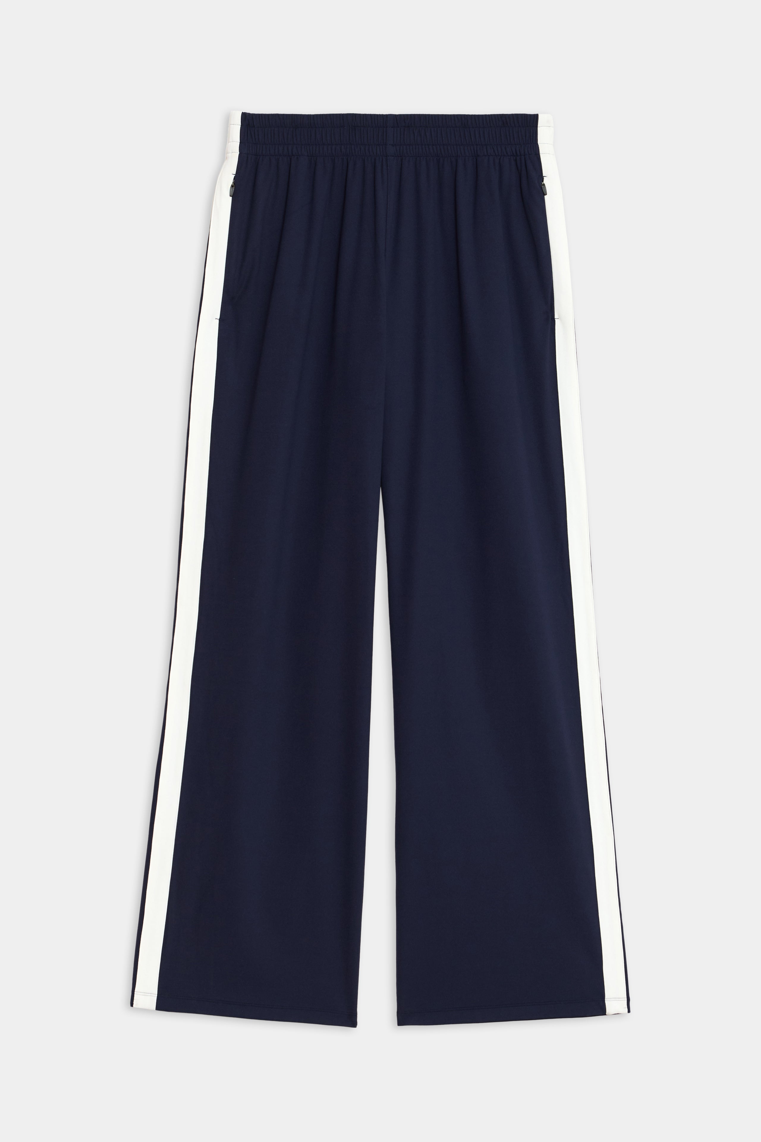 Maxie Rigor Track Pant by SPLITS59, featuring a navy color with an elastic waistband and white side stripes, showcased on a plain background.