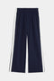 Maxie Rigor Track Pant by SPLITS59, featuring a navy color with an elastic waistband and white side stripes, showcased on a plain background.