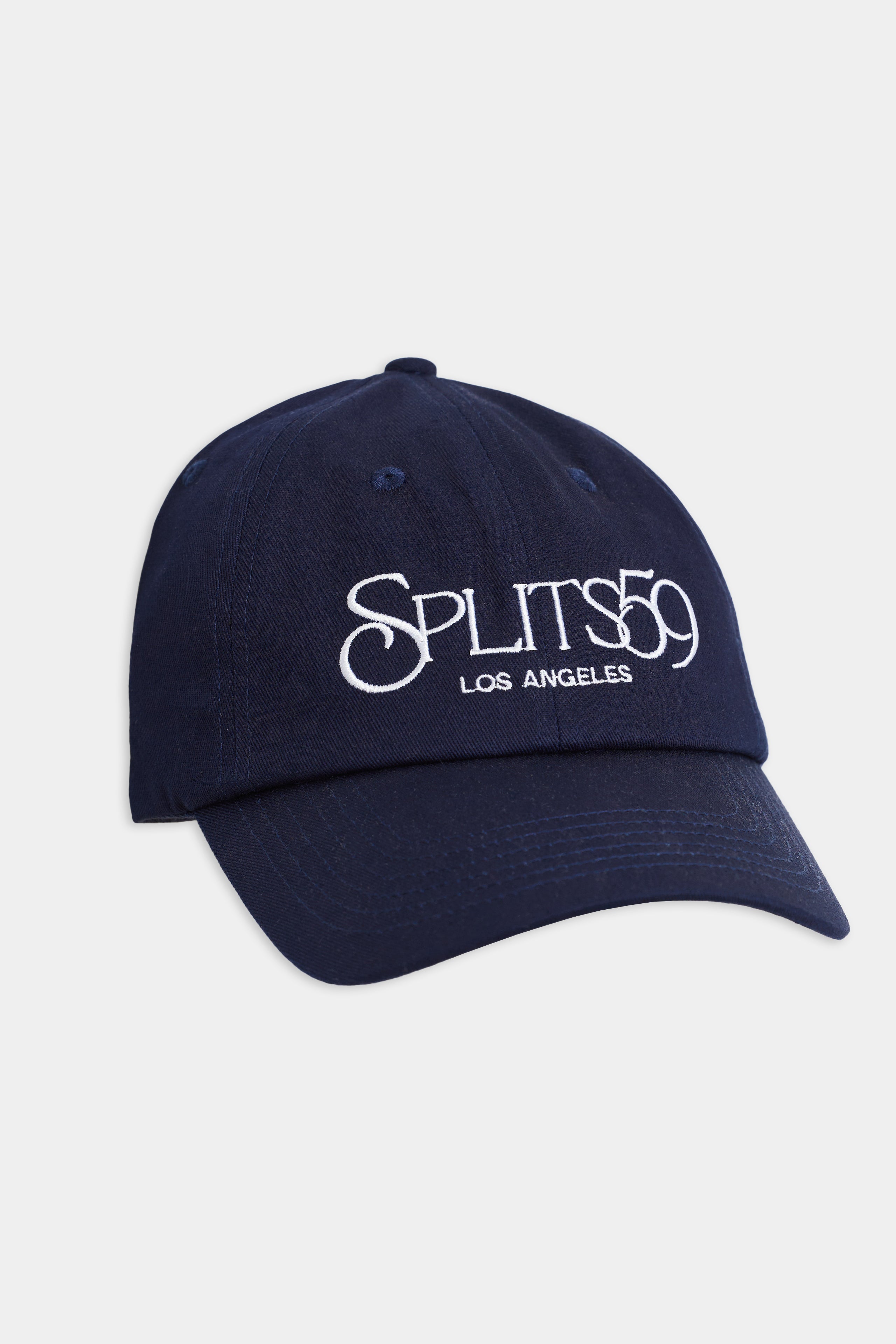 The Tennis Cap in indigo from SPLITS59 showcases "Los Angeles" embroidery in a crisp white on the front.