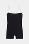 The Monah Rigor Jumpsuit by SPLITS59 is a black one-piece featuring a Monah silhouette with contrasting white straps and trim, crafted from durable Rigor fabric for high-intensity workouts, shown against a plain white background.