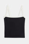 The Monah Rigor Tank by SPLITS59 is designed for gym workouts, showcasing a black camisole style with white straps and trim, elegantly presented on a plain white background.