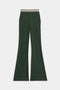 The SPLITS59 Raquel Active Rib Flare features dark green flared legs and a white and black striped elastic waistband, shown against a plain white background.