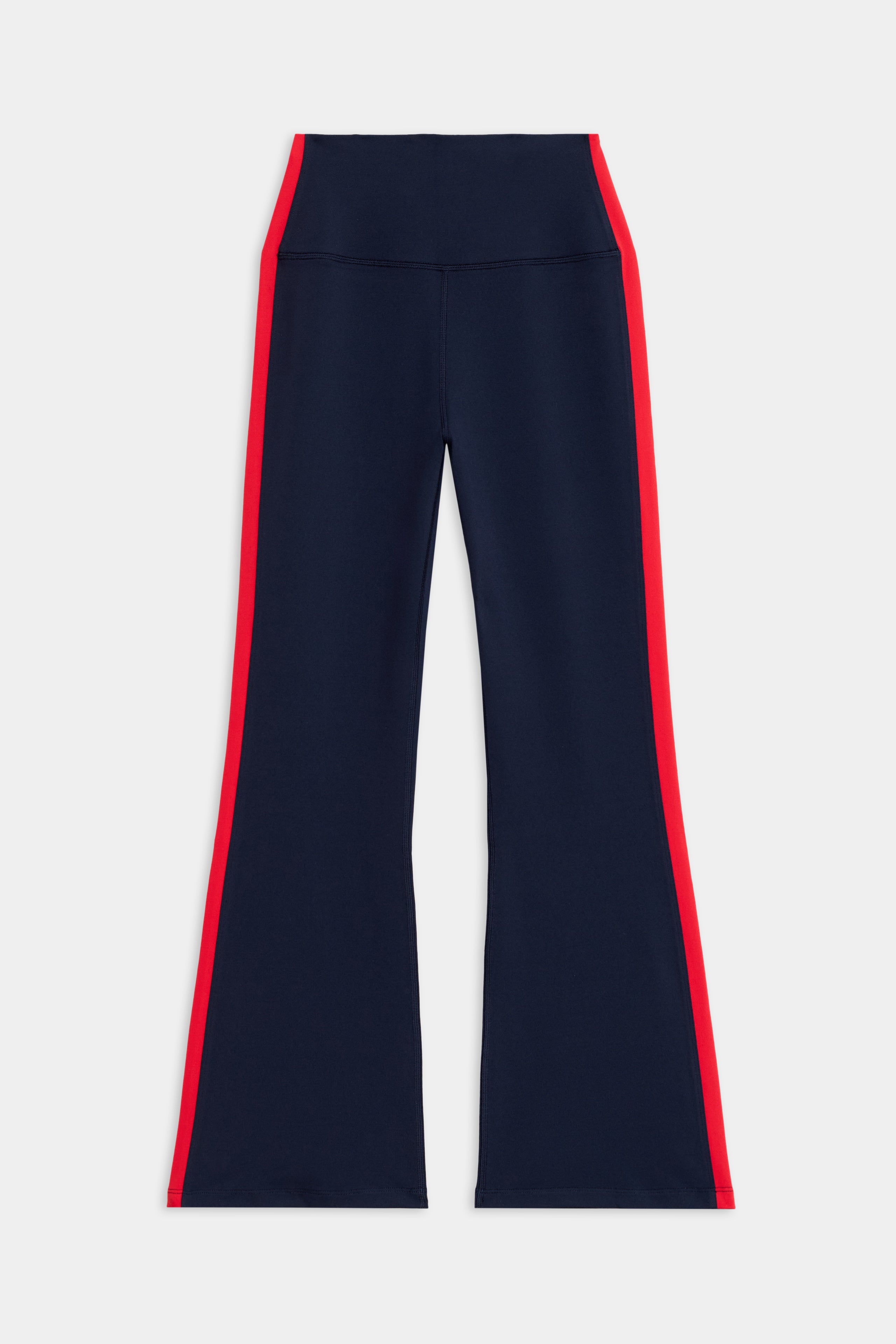 The SPLITS59 Raquel High Waist Crop features navy blue flared pants with wide red side stripes along the outer seams.