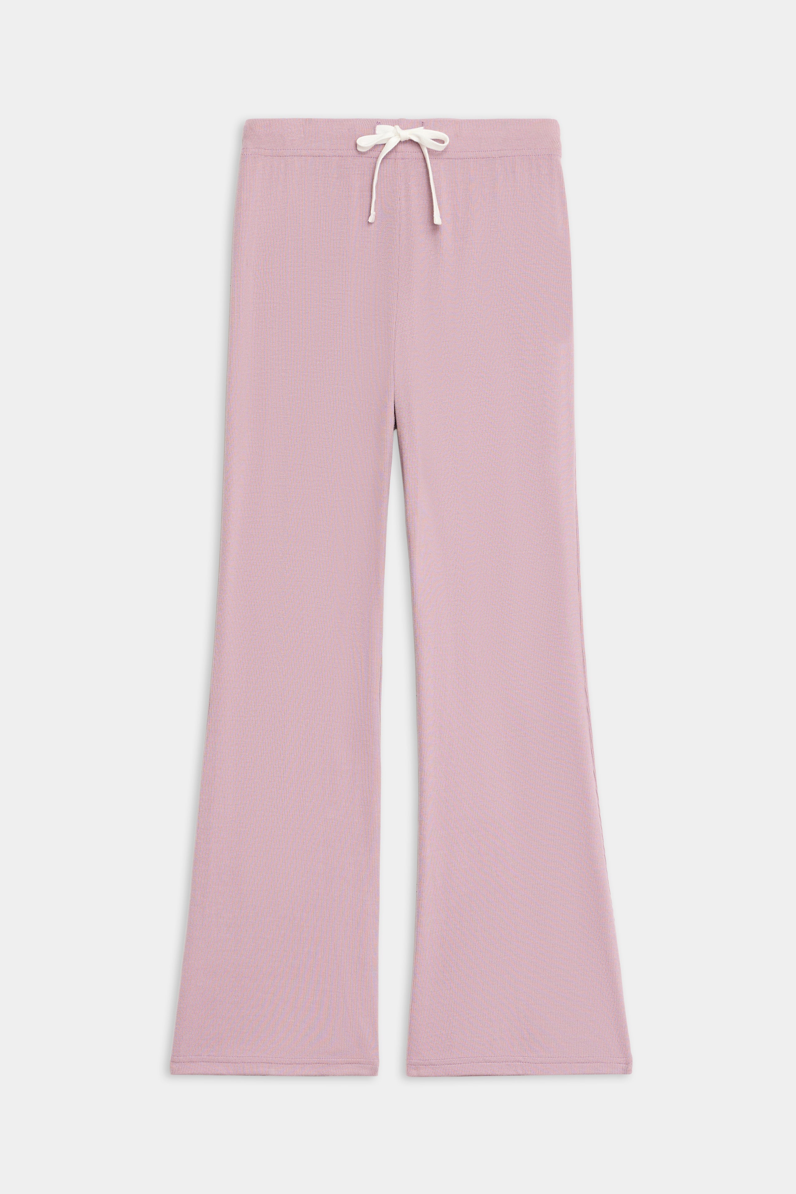 The SPLITS59 Blaire Rib Pant features a light pink, wide-leg knit design with an elastic waistband and white drawstring, shown laid flat on a plain white background.