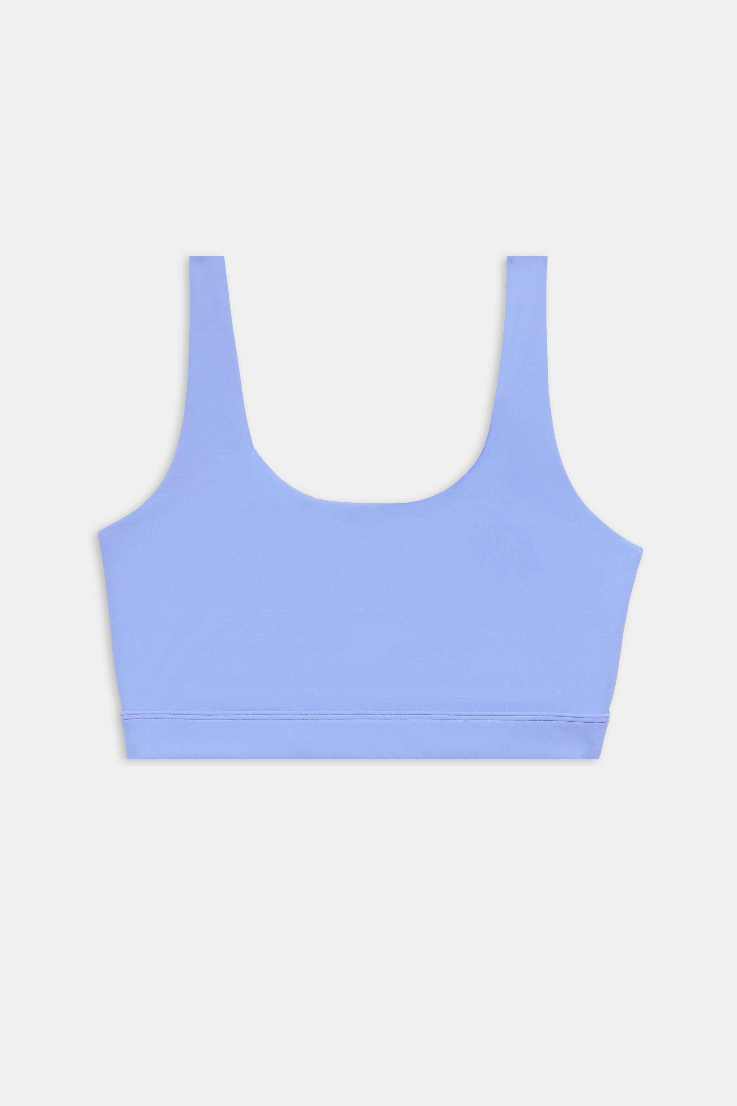A light blue sports bra with wide shoulder straps and a scoop neckline, displayed on a plain white background.