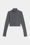 The Stevie Active Rib Half Zip by SPLITS59 is a gray long-sleeve crop top with a quarter-zip front and high collar, shown laid flat on a white background.