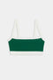 The SPLITS59 Monah Rigor Bra in Arugula/White is a green and white two-tone bralette with sleek white straps and trim, elegantly laid flat against a plain white background.
