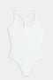 The SPLITS59 Suki Airweight Bodysuit in white is a soft nylon-spandex one-piece with a racerback design, shown on a flat white background.