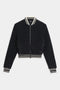 The SPLITS59 Willa Sherpa Jacket - Black is a cozy baseball-style bomber with a front zipper and white-striped ribbed trim—ideal for winter workouts. Shown here against a white background.