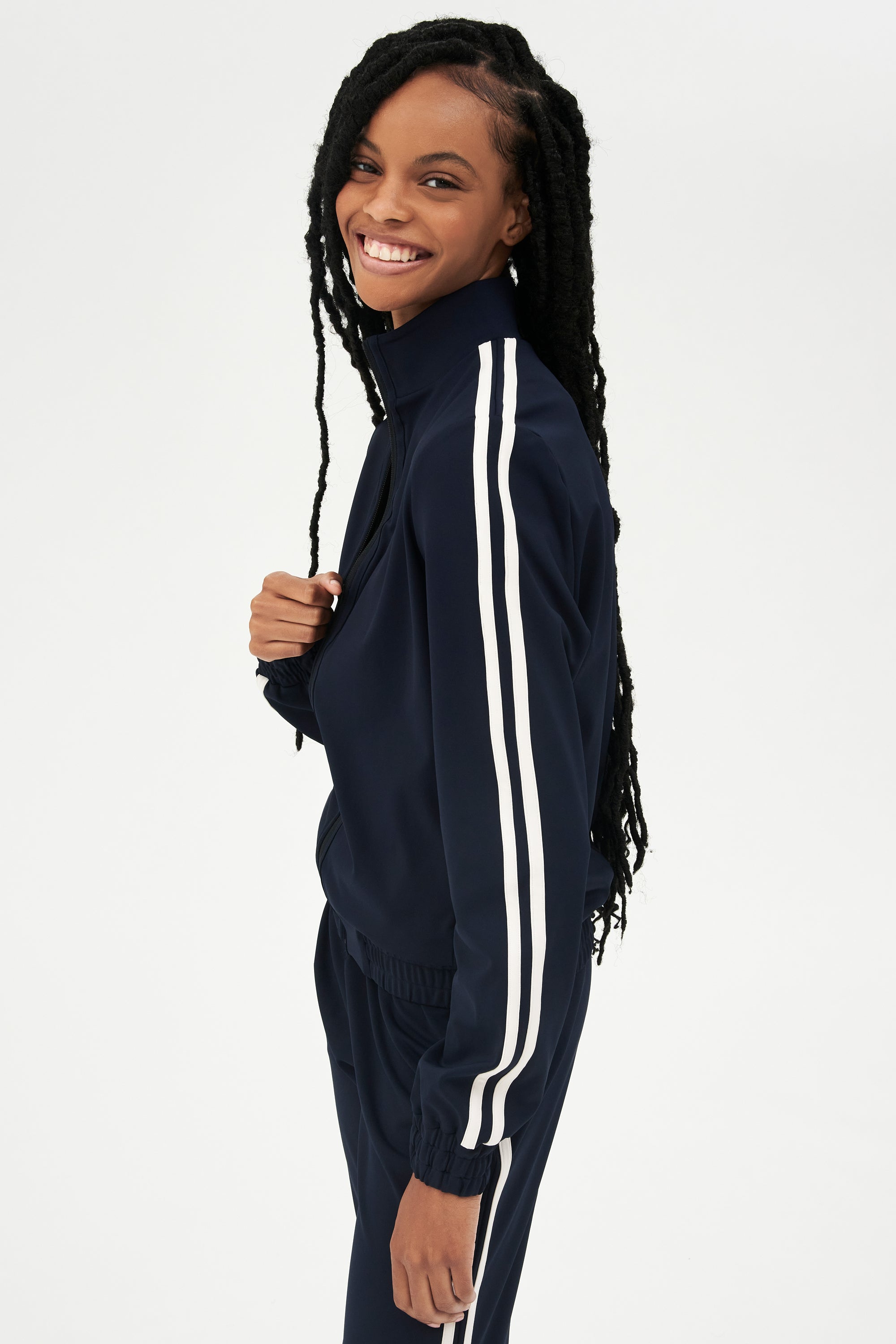 Woman smiling in a SPLITS59 Fox Techflex Jacket in Indigo/Vintage White with white stripes.